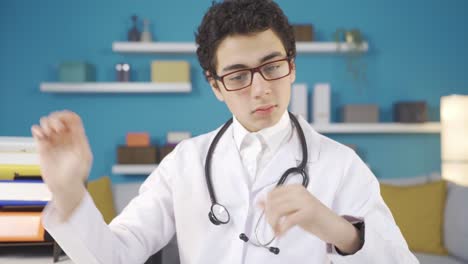 Boy-dressed-as-doctor-in-white-uniform-and-wearing-stethoscope-dreams-of-being-a-doctor-at-home.